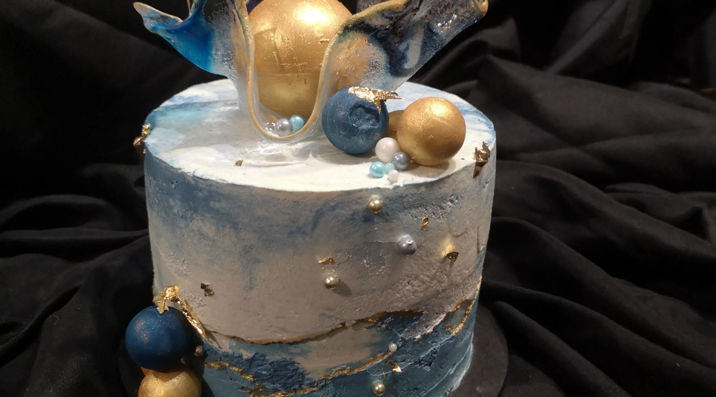 Blue, white and gold sugar cake with edible sugar glass sculpture and blue and gold edible baubles